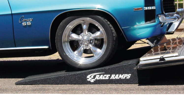 blue camaro going up trailer ramp